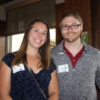 Two alumni smiling for camera